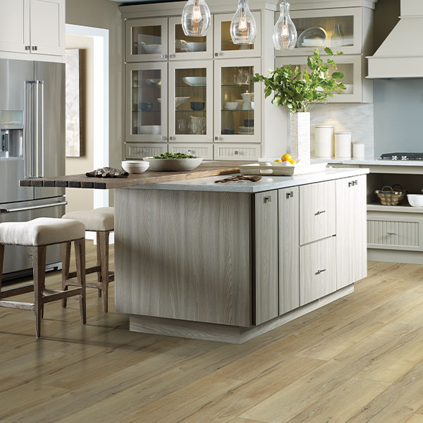 wood look flooring in kitchen with wood island and natural decor